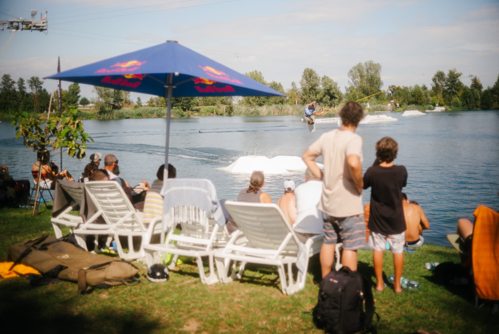 Young riders and families watching the cable from the lakeside